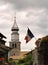 View on church in medieval French village, Yvoire, with a waving flag