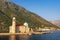 View of Church of Our Lady of the Rocks Gospa od Skrpjela on sunny summer day. Montenegro, Bay of Kotor