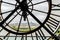 View of church Sacre Coeur in Montmartre through a large Clock from Museum d`Orsay in Paris