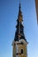 View of a church tower in the background with a maypole in the foreground