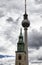 View of church tower in front of television tower