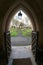 View of churchyard through church porch