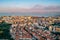 View of the city from above, the statue of Christ on the banks of the Tagus River, narrow streets and roofs of houses with red til