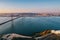 View of the city from above, the statue of Christ on the banks of the Tagus River, narrow streets and roofs of houses with red til