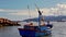 View of City across Sea Bay Close Fishing Boat Cloudy Sky