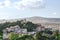 View of the city of Athens, the church and the mountains from the Acropolis. Green trees and blue sky