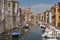 View of the city of Chioggia with wooden boats and bridge over canal, little Venice Italy