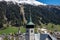 View from the city Davos with historic churches with snowy mountains