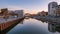 View of city Gdansk at sunrise. The promenade along the riverbank of Motlawa River.