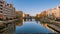 View of city Gdansk at sunrise. The promenade along the riverbank of Motlawa River.