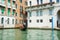 View of the city Grand Canal in Venice in a sunny day. Gondolier driving the gondola in Venice, Italy