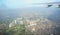 A view of the city of Manila through the window from the plane. Impressed photo of a tourist in flight over the capital