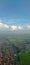 The view of the city, mountains, rice fields and blue clouds shot from the plane window looks beautiful