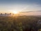 View of city from the park at sunrise time. golden rising sun in