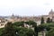 View of the city of Rome, buildings, roofs, pine on a rainy day