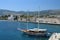 View on city wall of Kos City with sailing boat in front and mountains in the background