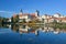 View of the cityscape of Telc and reflection in water.