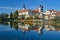 View of the cityscape of Telc and reflection in water.