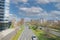 View on cityscape with urban multilane expressway against blue sky, fluffy clouds