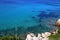 View of the clear azure water and stones with green coniferous trees. green grass coastal Sithonia, Halkidiki, Greece.