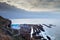 View of a cliff over a coastline with a beautiful misty sea from a view point on a beach in Mossel Bay, Cape Town