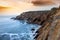 View of a cliff over a coastline with a beautiful misty sea from a view point on a beach in Mossel Bay, Cape Town