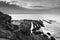 View of a cliff over a coastline with a beautiful misty sea from a view point on a beach in Mossel Bay, Cape Town