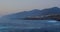 View of cliffs at sunset during golden blue hour, picturesque scenery, calm Atlantic Ocean waves. Los Gigantes. Tenerife