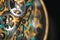 The view is close. Mechanism of a wristwatch. Gears, levers, springs and gems. Engraving and gold. old scratched glass. Concept of