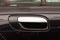 View on closed black front door with handle made from chromium of luxury car after detailing and