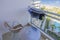 View of clothes dryer on balcony with table and armchairs in hotel room.