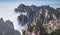 View of the clouds and the pine tree at the mountain peaks of Huangshan National park, China. Landscape of Mount Huangshan of the