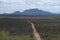 View of cloudy mountain landscape with dirt road, Benguela