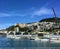 A view from Clyde Quay Wharf of sailboats anchored in Lambton Harbour with beautiful homes on the hills in the background