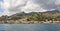 view of the coast of Giardini Naxos  mountains buildings below them   houses along the beach on the shores of the Ionian Sea