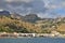 view of the coast of Giardini Naxos mountains buildings below them houses along the beach on the shores of the Ionian Sea