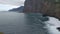 View of the coast of madeira island in the ocean. Waves wash the rocks of the island.