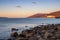 View from the coast to the sea bay, mountains and cargo seaport