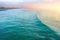 View of the coastal strip of the beach and big waves, evening at sunset