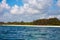 View of coastline with beach in Kenya, Africa. People, tourists on vacation and sea with waves and surf, under a blue sky