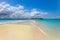 View of coastline of Iranja Island Nosy Iranja  lined with palm trees and boats floating in the sea, Madagascar