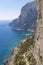 View of the coastline of the island of Capri, Italy, with one of its seaside rock formations known as the Faraglioni