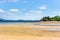 View of coastline on an Island lined with trees and boats floating in the sea, Madagascar