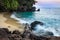 View of coastline on Nosy Komba Island lined with palm trees and boats floating in the sea at sunset, Nosy Komba