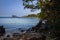 View of coastline on Nosy Komba Island lined with palm trees, Madagascar