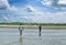 View of the coastline, the people, the men in clothes come out of the sea or ocean