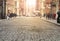 View of cobblestone covered Greene Street with bright sunlight background in the SoHo neighborhood of New York City