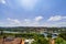 A view of Coimbra City under a clear sky, with Mondego River, trees, and buildings