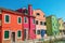 View of colorful buildings and boats in canal of Burano