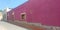 view of colorful house with pink wall in pueblo Zimapan Hidalgo Mexico